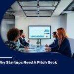 Business team in a modern conference room discussing charts and graphs displayed on a screen during a pitch deck meeting.